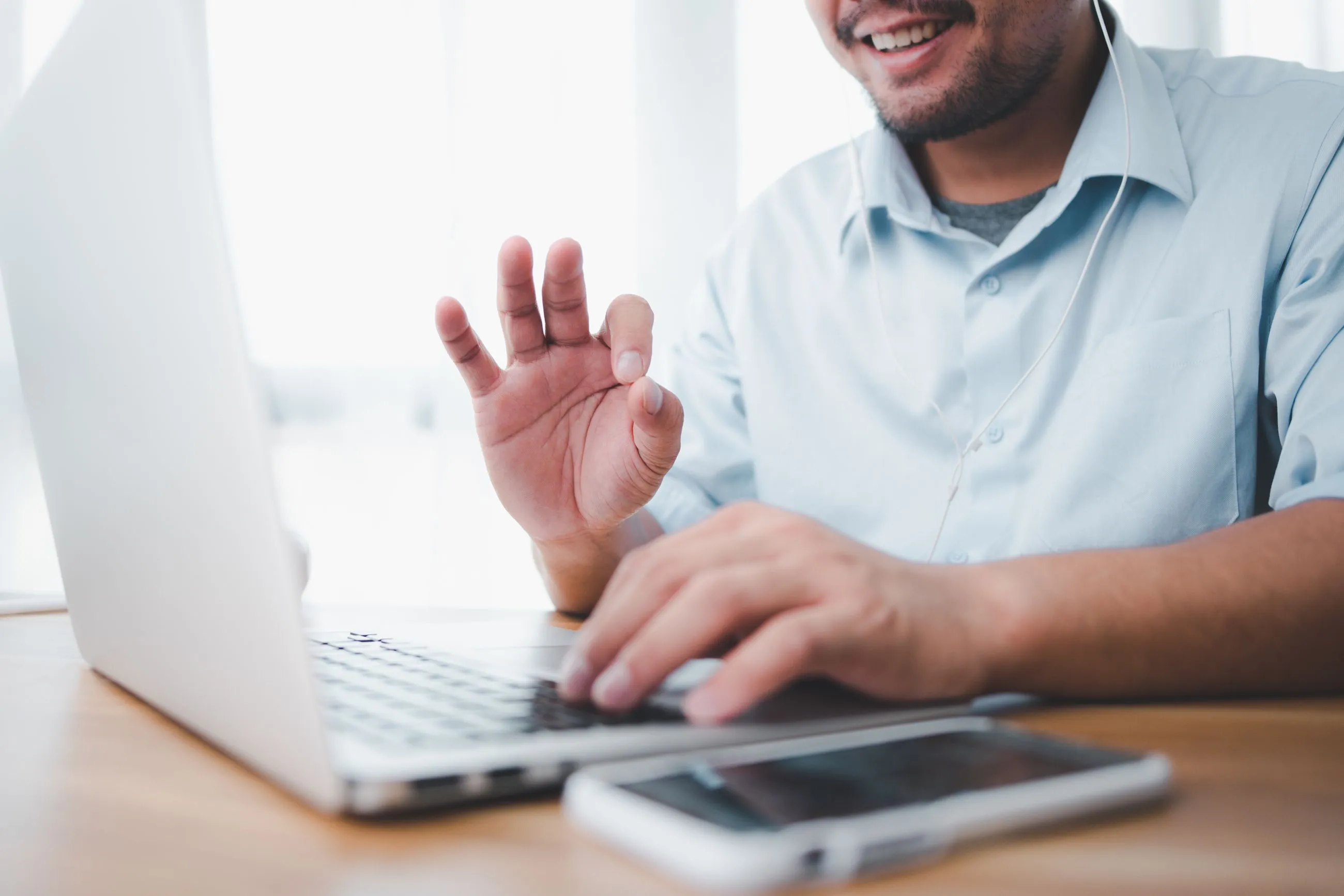 A man on a laptop on Zoom.