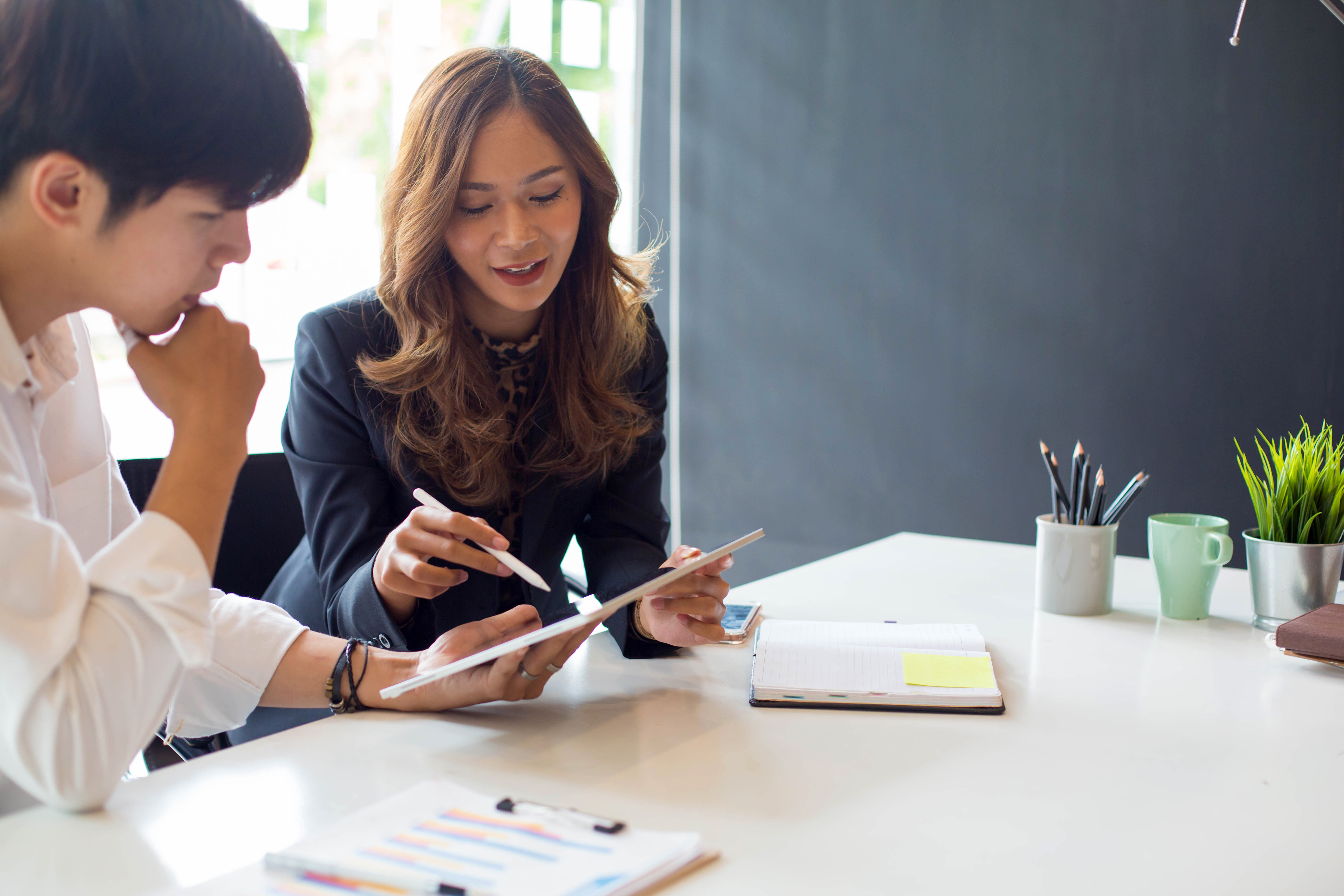 A woman going over reports with a client